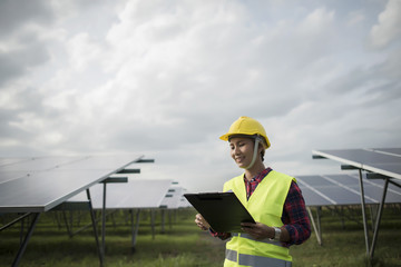 Engineer electric woman checking and maintenance of solar cells.