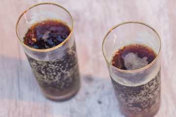 two jars of cold fresh russian kvass on wooden table outdoors