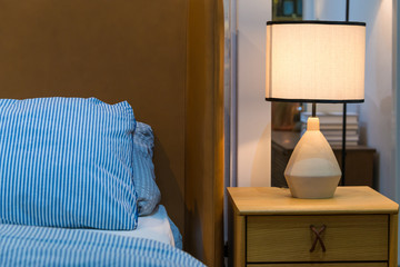 Bedside modern table bed lamp with cozy bedroom interior