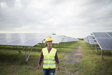 Engineer electric woman checking and maintenance of solar cells.