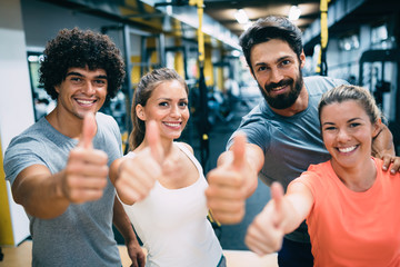 Portrait of cheerful fitness team in gym