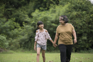 Fototapeta premium Grandmother Playing With Granddaughter Outdoors At The Park