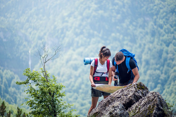 Hikers using map to navigate outdoor