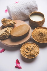Herbal or Ayurvedic face Pack using Multani mitti, milk etc placed with Soap, towel. Selective focus