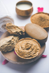 Herbal or Ayurvedic face Pack using Multani mitti, milk etc placed with Soap, towel. Selective focus