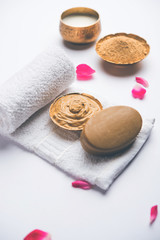 Herbal or Ayurvedic face Pack using Multani mitti, milk etc placed with Soap, towel. Selective focus