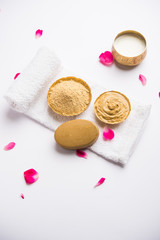 Herbal or Ayurvedic face Pack using Multani mitti, milk etc placed with Soap, towel. Selective focus