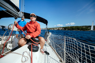 Attractive strong woman sailing with her boat