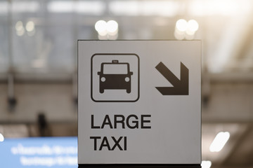 Large taxi sign at airport.