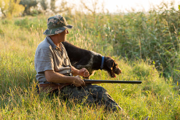 Hunter with a German trotter and spaniel, hunting a pheasant with dogs