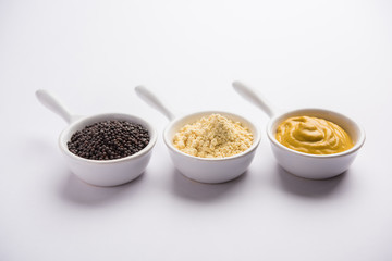 Rai or raw Mustard with sauce, powder and oil, over moody background. Selective focus
