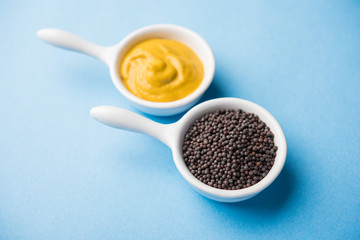 Rai or raw Mustard with sauce, powder and oil, over moody background. Selective focus
