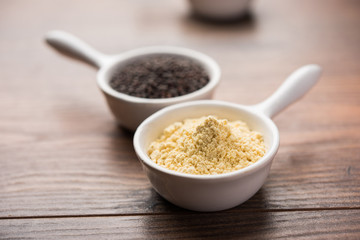 Rai or raw Mustard with sauce, powder and oil, over moody background. Selective focus
