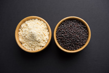 Rai or raw Mustard with sauce, powder and oil, over moody background. Selective focus
