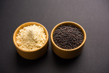 Rai or raw Mustard with sauce, powder and oil, over moody background. Selective focus
