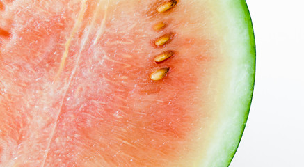 slice of delicious ripe watermelon on a white background, macro photograph of watermelon