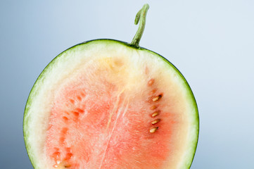 watermelon cut in halves isolated on gray background