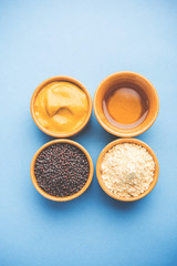 Rai or raw Mustard with sauce, powder and oil, over moody background. Selective focus
