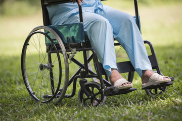Obraz premium Close up Lonely elderly woman sitting on wheelchair at garden in hospital