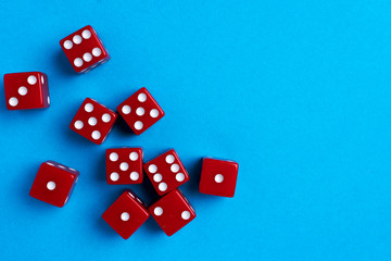 Red gaming dices on blue background. Flat lay, place for text. Game concept