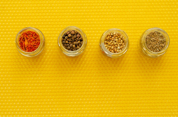 spices in jars on the background of beeswax
