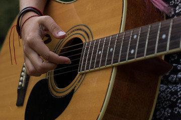 music acoustic guitar instrument concept of right female hand on string
