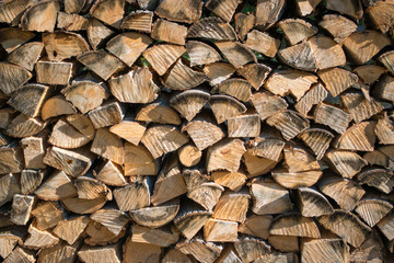 Cut split stacked firewood for winter background close-up