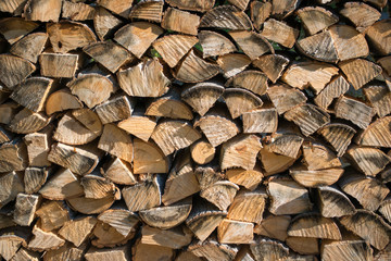 Cut split stacked firewood for winter background close-up