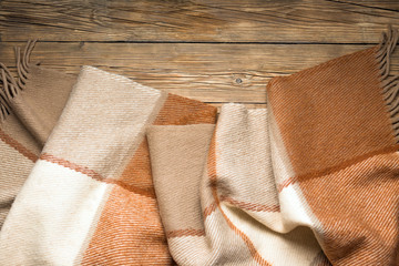 Warm wool throw on wooden background, blanket