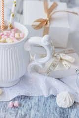Cup of cacao with marshmallow, meringues and different Christmas decorations