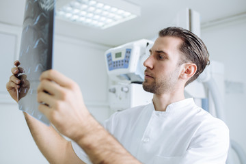 Technician Examining X-ray Films