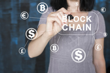 Businessman presses button blockchain currency on virtual electronic user interface.