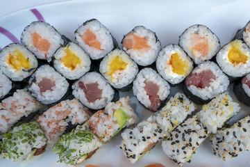 Assorted sushi set served on white plate.