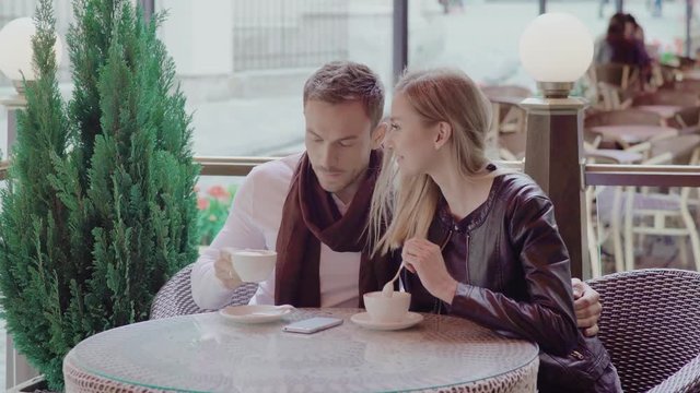 Romantic Couple Drinking Coffee On Date At Street Cafe