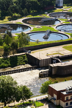 Sewage water treatment plant with storage tanks, aerial view, sunny summer day
