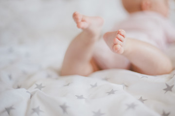 Obraz na płótnie Canvas Little baby feet on a swaddle blanket