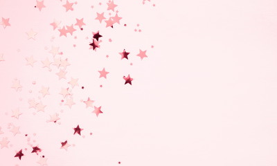 Festive pink background. Shining stars on light pink pastel background. Christmas. Wedding. Birthday. Happy woman's day. Mothers Day. Valentine's Day. Flat lay, top view, copy space. 