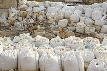 Lot of big white sandbags for flood defense.
