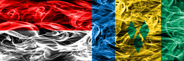 Indonesia vs Saint Vincent and the Grenadines smoke flags placed side by side. Thick colored silky...