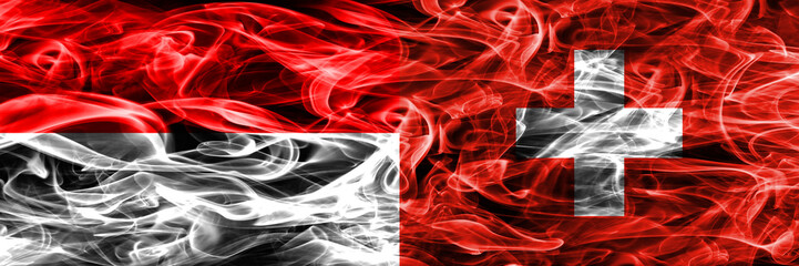 Indonesia vs Switzerland smoke flags placed side by side. Thick colored silky smoke flags of Indonesian and Switzerland