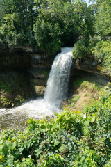Fototapeta na wymiar Beautiful summer time view of Minnehaha falls nature park in Minneapolis Minnesota during day time. Attraction for tourists and residents to enjoy the great outdoors