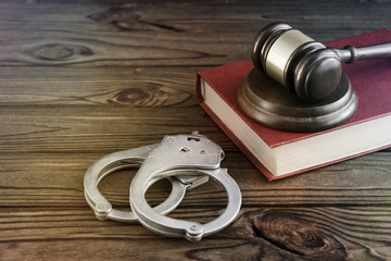 hammer of a judge, a book, handcuffs of iron for the detention of criminals. Law. Criminal law....