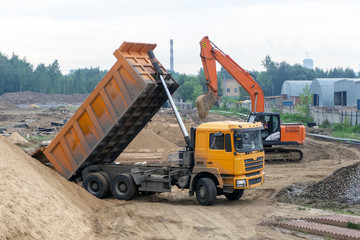Delivery of sand by truck to the construction site