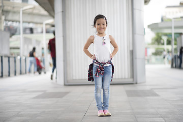 Smart little girl child standing in city