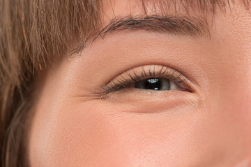 Obraz premium The close up gray eye on face of young beautiful caucasian girl