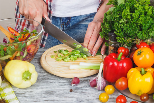 Woman cooks on the kitchen, soft focus background