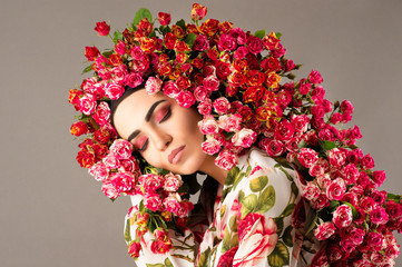 Beauty woman model with red roses flower wreath and fashion makeup face