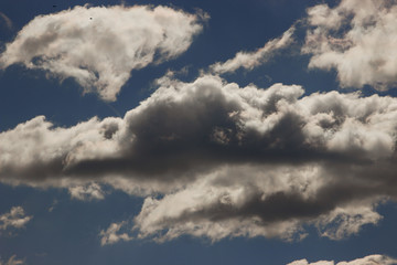 View on beautiful white and gray clouds in a blue sky.