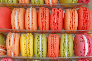 close up of color macaroons on shopwindow