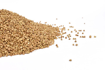 Spread buckwheat on a white background